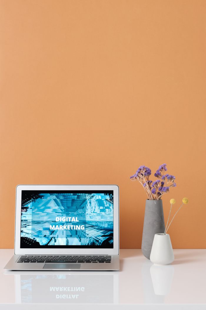 who-we-are Modern workspace with laptop and decorative flowers showcasing digital marketing.