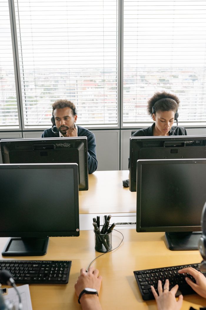 Colleagues in a modern call center working diligently with headsets.